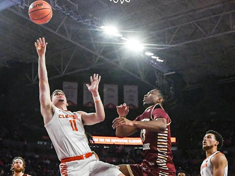 Jan 13, 2024; Clemson, South Carolina, USA; Clemson Tigers guard Joseph Girard III shoots the ball against Boston College Eagles guard Donald Hand (13) during the second half at Littlejohn Coliseum. Mandatory Credit: Ken Ruinard-USA TODAY Sports