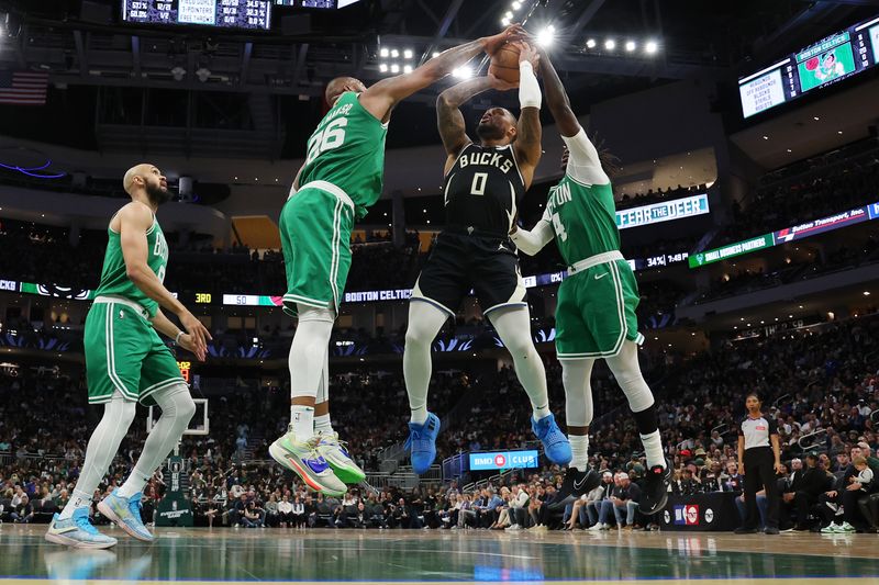 MILWAUKEE, WISCONSIN - APRIL 09: Xavier Tillman #26 of the Boston Celtics blocks a shot by Damian Lillard #0 of the Milwaukee Bucks during a game at Fiserv Forum on April 09, 2024 in Milwaukee, Wisconsin. NOTE TO USER: User expressly acknowledges and agrees that, by downloading and or using this photograph, User is consenting to the terms and conditions of the Getty Images License Agreement. (Photo by Stacy Revere/Getty Images)