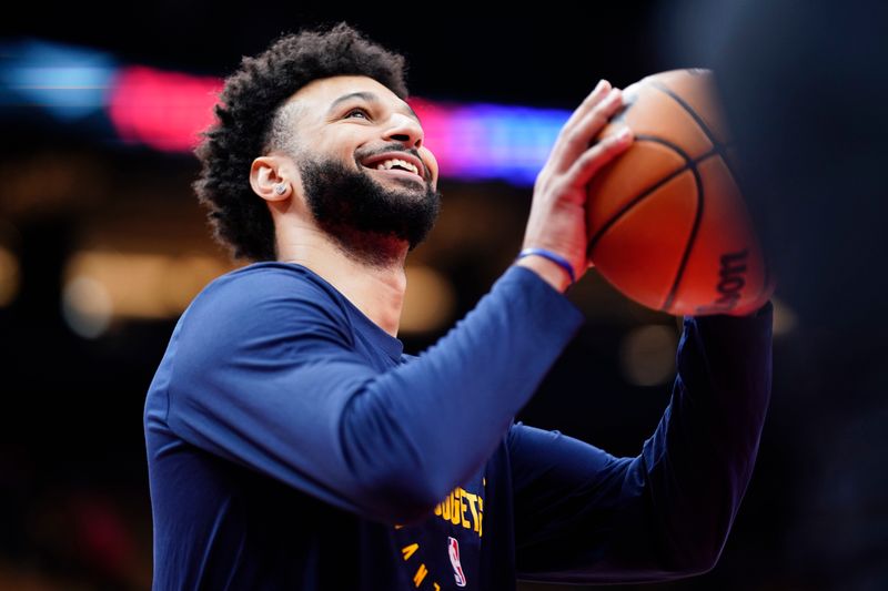 TORONTO, CANADA - OCTOBER 28: Jamal Murray #27 of the Denver Nuggets smiles during the warm up before the game against the Toronto Raptors on October 28, 2024 at the Scotiabank Arena in Toronto, Ontario, Canada.  NOTE TO USER: User expressly acknowledges and agrees that, by downloading and or using this Photograph, user is consenting to the terms and conditions of the Getty Images License Agreement.  Mandatory Copyright Notice: Copyright 2024 NBAE (Photo by Mark Blinch/NBAE via Getty Images)