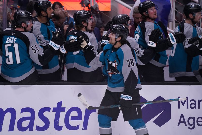 Oct 30, 2025; San Jose, California, USA;  San Jose Sharks defenseman Mario Ferraro (38) celebrates with the bench after assisting on a goal against the New Jersey Devils in the first period at SAP Center at San Jose. Mandatory Credit: David Gonzales-Imagn Images