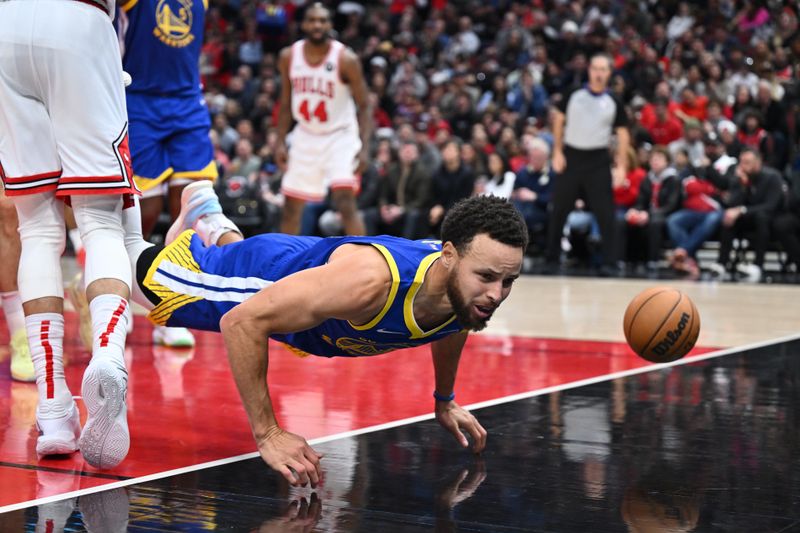 CHICAGO, ILLINOIS - JANUARY 12:  Stephen Curry #30 of the Golden State Warriors falls to the floor after losing control of the ball in the second half against the Chicago Bulls on January 12, 2024 at United Center in Chicago, Illinois. Golden State defeated Chicago 140-131.   NOTE TO USER: User expressly acknowledges and agrees that, by downloading and or using this photograph, User is consenting to the terms and conditions of the Getty Images License Agreement.  (Photo by Jamie Sabau/Getty Images)