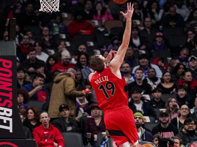 TORONTO, ON - DECEMBER 1: Jakob Poeltl #19 of the Toronto Raptors drives to the basket against Tyler Herro #14 of the Miami Heat at Scotiabank Arena on December 1, 2024 in Toronto, Ontario, Canada. NOTE TO USER: User expressly acknowledges and agrees that, by downloading and/or using this Photograph, user is consenting to the terms and conditions of the Getty Images License Agreement. (Photo by Andrew Lahodynskyj/Getty Images)