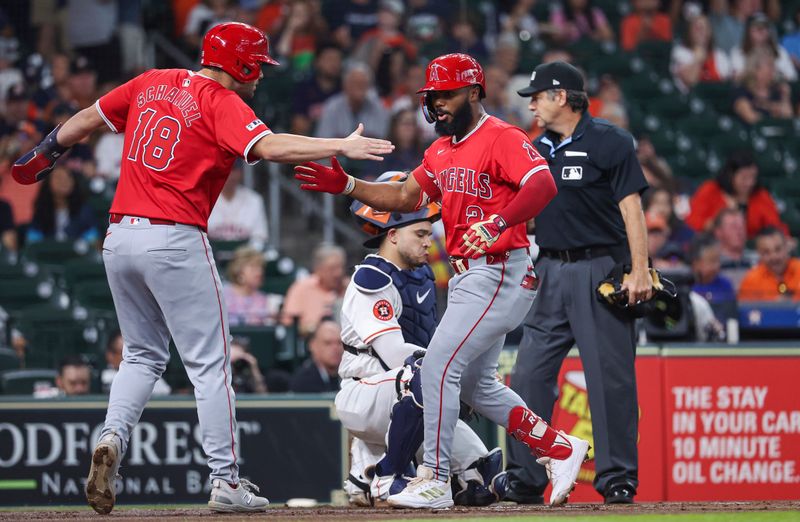 May 21, 2024; Houston, Texas, USA; Los Angeles Angels third baseman Luis Rengifo (2) celebrates with first baseman Nolan Schanuel (18) afer hitting a home run during the first inning against the Houston Astros at Minute Maid Park. Mandatory Credit: Troy Taormina-USA TODAY Sports