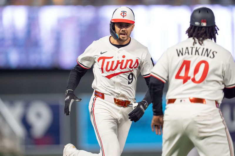 Apr 23, 2025; Minneapolis, Minnesota, USA; Minnesota Twins right fielder Trevor Larnach (9) celebrates with Minnesota Twins third base coach/outfield coach Tommy Watkins (40) as he rounds third base after hitting a home run off Chicago White Sox pitcher Jordan Leasure (49) in the sixth inning at Target Field. Mandatory Credit: Matt Blewett-Imagn Images