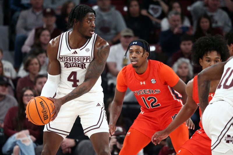 Jan 27, 2024; Starkville, Mississippi, USA; Mississippi State Bulldogs forward Cameron Matthews (4) handles the ball as Auburn Tigers guard Denver Jones (12) defends during the first half at Humphrey Coliseum. Mandatory Credit: Petre Thomas-USA TODAY Sports