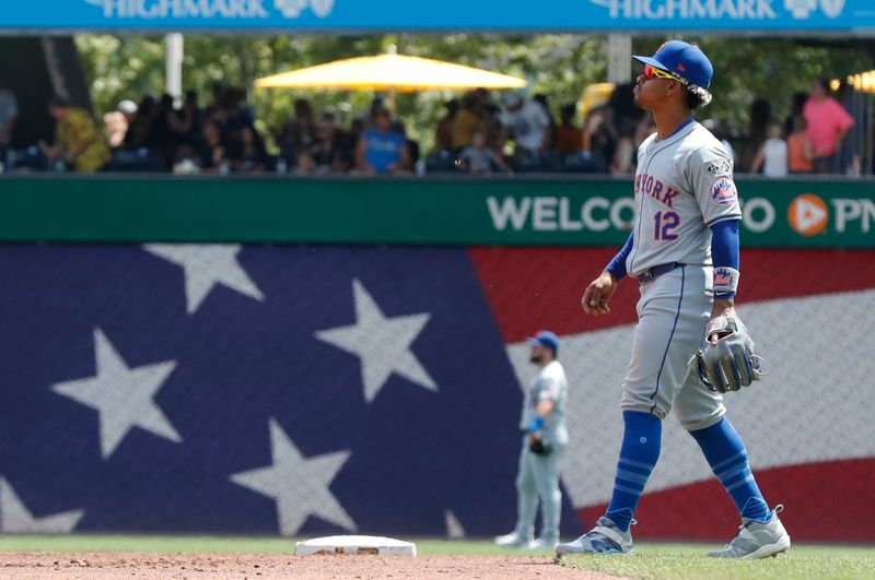 Jul 7, 2024; Pittsburgh, Pennsylvania, USA;  New York Mets shortstop Francisco Lindor (12) )takes his position in the field against the Pittsburgh Pirates during the third inning at PNC Park. Mandatory Credit: Charles LeClaire-USA TODAY Sports