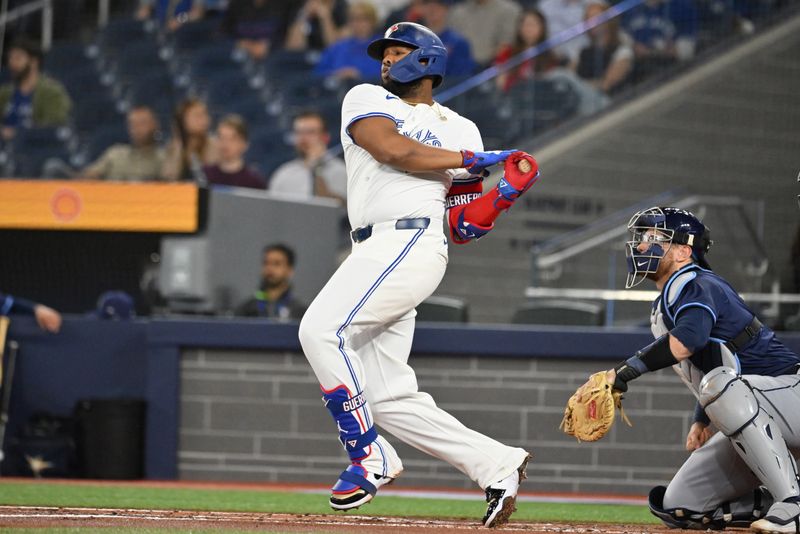 May 14, 2025; Toronto, Ontario, CAN;  Toronto Blue Jays first baseman Vladimir Guerrero Jr. (27) hits a single against the Tampa Bay Rays in the first inning at Rogers Centre. Mandatory Credit: Dan Hamilton-Imagn Images