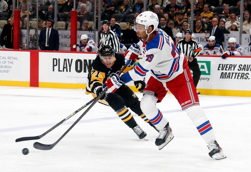 Oct 9, 2024; Pittsburgh, Pennsylvania, USA;  New York Rangers defenseman K'Andre Miller (79) moves the puck against Pittsburgh Penguins center Evgeni Malkin (71) during the third period at PPG Paints Arena. TMandatory Credit: Charles LeClaire-Imagn Images