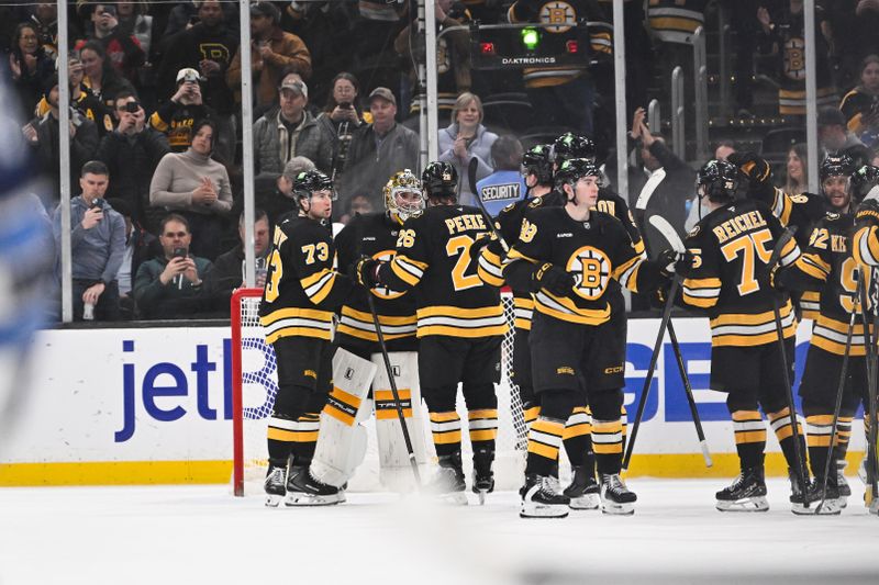 Mar 19, 2026; Boston, Massachusetts, USA; Boston Bruins goaltender Jeremy Swayman (1) celebrates defeating the Winnipeg Jets with defenseman Andrew Peeke (26) and defenseman Charlie McAvoy (73) at TD Garden. Mandatory Credit: Eric Canha-Imagn Images