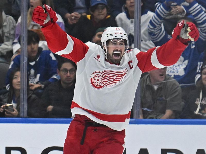 Oct 13, 2025; Toronto, Ontario, CAN; Detroit Red Wings center Dylan Larkin (71) celebrates the winning goal by center Mason Appleton (22) (not shown) in the third period against the Toronto Maple Leafs at Scotiabank Arena. Mandatory Credit: Gerry Angus-Imagn Images