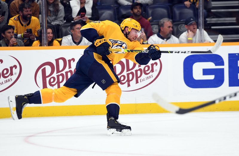 Oct 13, 2022; Nashville, Tennessee, USA; Nashville Predators center Yakov Trenin (13) shoots the puck during the first period against the Dallas Stars at Bridgestone Arena. Mandatory Credit: Christopher Hanewinckel-USA TODAY Sports