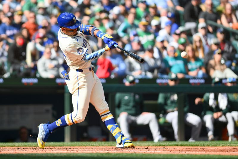 Sep 29, 2024; Seattle, Washington, USA; Seattle Mariners center fielder Julio Rodriguez (44) hits an RBI single against the Oakland Athletics during the fifth inning at T-Mobile Park. Mandatory Credit: Steven Bisig-Imagn Images