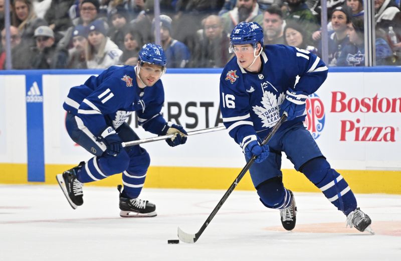 Jan 14, 2024; Toronto, Ontario, CAN;  Toronto Maple Leafs forward Mitchell Marner (16) skates with the puck as forward Max Domi (11) trails him in the third period against the Detroit Red Wings at Scotiabank Arena. Mandatory Credit: Dan Hamilton-USA TODAY Sports