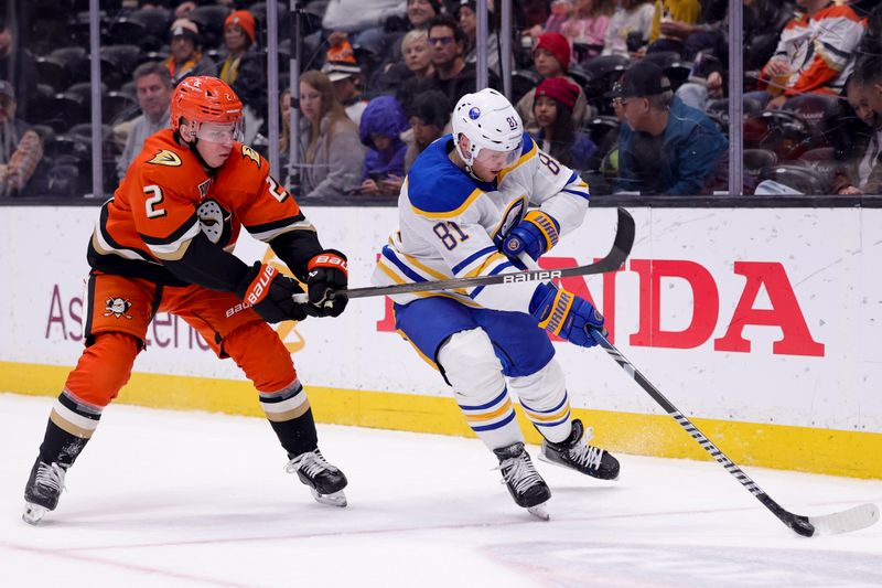 Nov 22, 2024; Anaheim, California, USA; Buffalo Sabres center Sam Lafferty (81) moves the puck against Anaheim Ducks defenseman Jackson LaCombe (2) during the third period at Honda Center. Mandatory Credit: Ryan Sun-Imagn Images