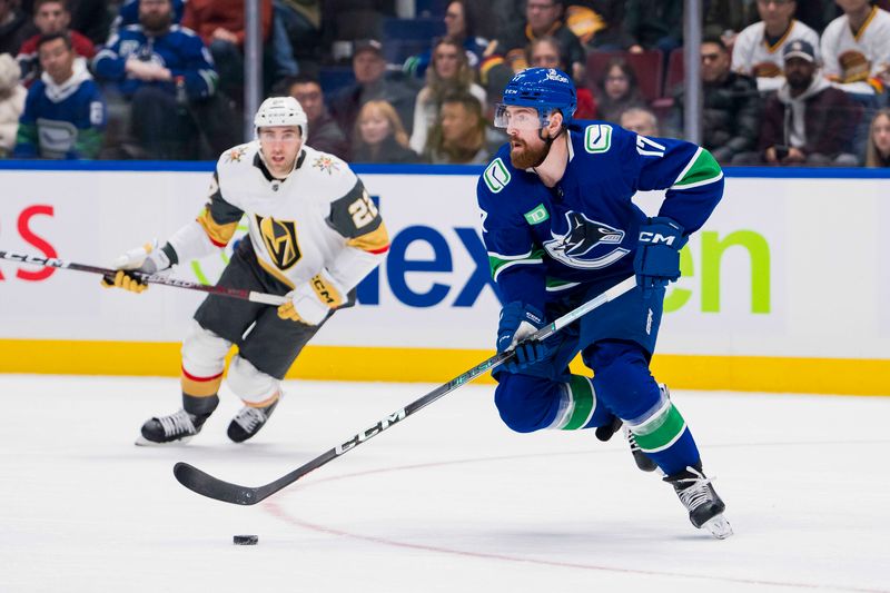 Nov 30, 2023; Vancouver, British Columbia, CAN; Vancouver Canucks defenseman Filip Hronek (17) handles the puck against the Vegas Golden Knights in the third period at Rogers Arena. Vegas won 4-1. Mandatory Credit: Bob Frid-USA TODAY Sports