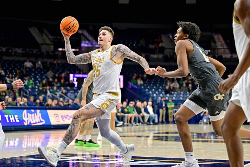 Jan 28, 2025; South Bend, Indiana, USA; Notre Dame Fighting Irish forward Nikita Konstantynovskyi (25) drives to the basket as Georgia Tech Yellow Jackets center Ryan Mutombo (12) defends in the first half at the Purcell Pavilion. Mandatory Credit: Matt Cashore-Imagn Images