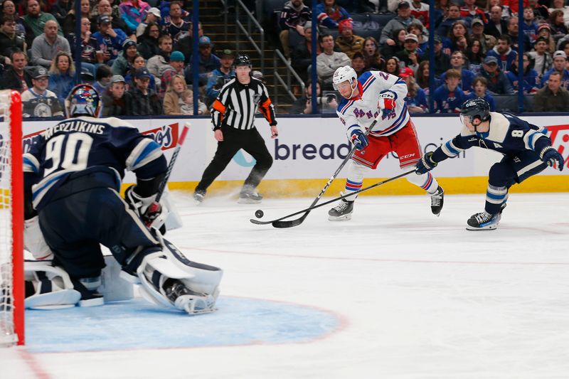 Feb 25, 2024; Columbus, Ohio, USA; New York Rangers center Jonny Brodzinski(22) wrists a shot on goal as Columbus Blue Jackets defenseman Zach Werenski (8) trails the play during the third period at Nationwide Arena. Mandatory Credit: Russell LaBounty-USA TODAY Sports