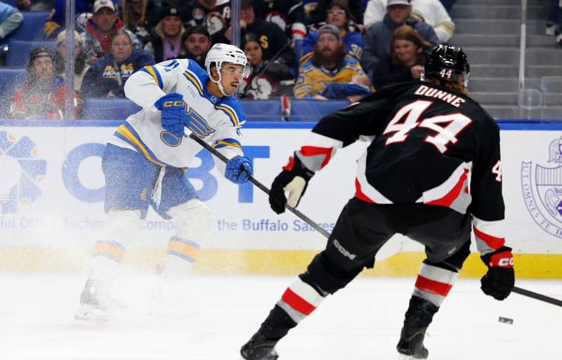 Nov 6, 2025; Buffalo, New York, USA;  Buffalo Sabres center Josh Dunne (44) tries to block a pass by St. Louis Blues right wing Mathieu Joseph (71) during the third period at KeyBank Center. Mandatory Credit: Timothy T. Ludwig-Imagn Images