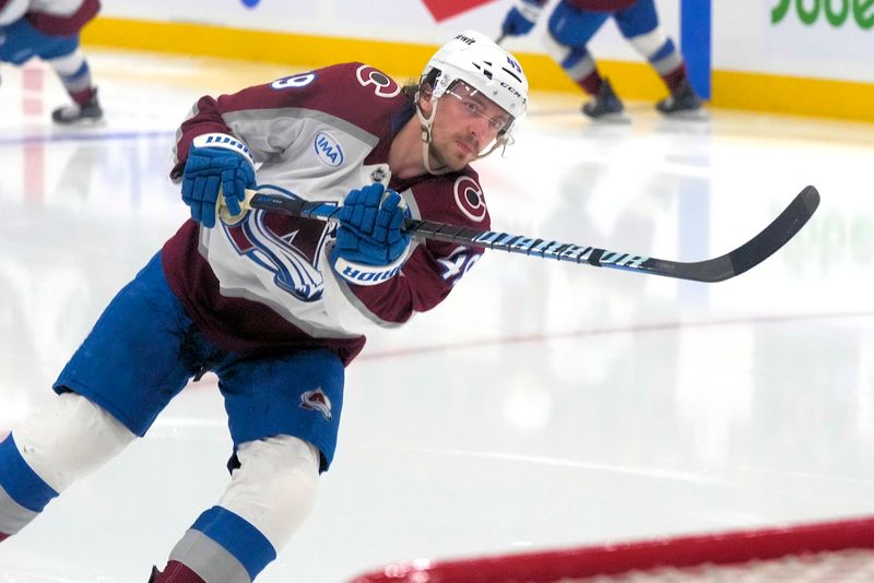 Mar 19, 2025; Toronto, Ontario, CAN; Colorado Avalanche defenseman Samuel Girard (49) shoots the puck during during warm up before a game against the Toronto Maple Leafs at Scotiabank Arena. Mandatory Credit: John E. Sokolowski-Imagn Images