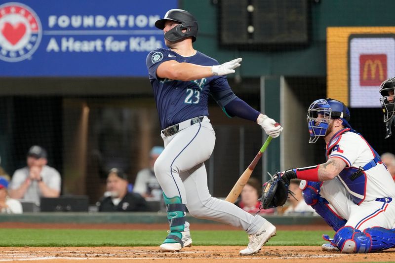 Apr 24, 2024; Arlington, Texas, USA; Seattle Mariners first base Ty France (23) follows through on his single against the Texas Rangers during the first inning at Globe Life Field. Mandatory Credit: Jim Cowsert-USA TODAY Sports