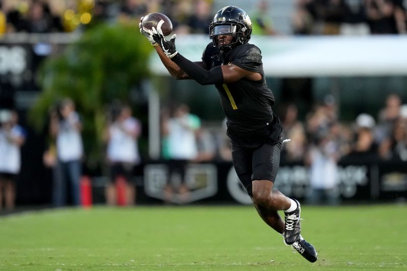 Oct 29, 2022; Orlando, Florida, USA; UCF Knights wide receiver Javon Baker (1) completes a catch against the Cincinnati Bearcats in the fourth quarter at FBC Mortgage Stadium. UCF won 25-21. Mandatory Credit: Kareem Elgazzar/The Cincinnati Enquirer Sentinel via USA TODAY NETWORK