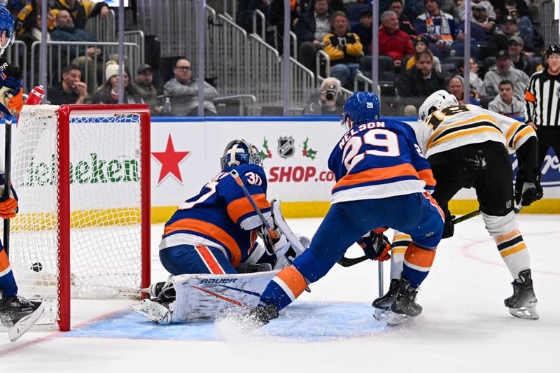 Nov 27, 2024; Elmont, New York, USA;  Boston Bruins center Pavel Zacha (18) scores a goal past New York Islanders goaltender Ilya Sorokin (30) defended by New York Islanders center Brock Nelson (29) during the third period at UBS Arena. Mandatory Credit: Dennis Schneidler-Imagn Images