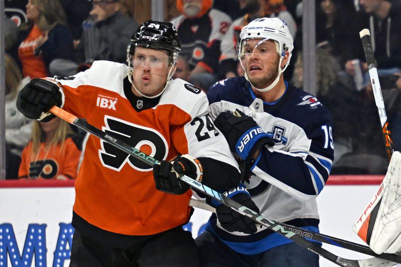 Oct 16, 2025; Philadelphia, Pennsylvania, USA; Philadelphia Flyers defenseman Nick Seeler (24) and Winnipeg Jets center Jonathan Toews (19) battle for position during the first period at Wells Fargo Center. Mandatory Credit: Eric Hartline-Imagn Images