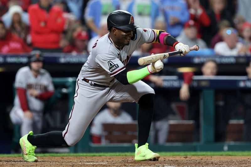 Oct 24, 2023; Philadelphia, Pennsylvania, USA; Arizona Diamondbacks shortstop Geraldo Perdomo (2) lays down a bunt against the Philadelphia Phillies in the fifth inning for game seven of the NLCS for the 2023 MLB playoffs at Citizens Bank Park. Mandatory Credit: Bill Streicher-USA TODAY Sports