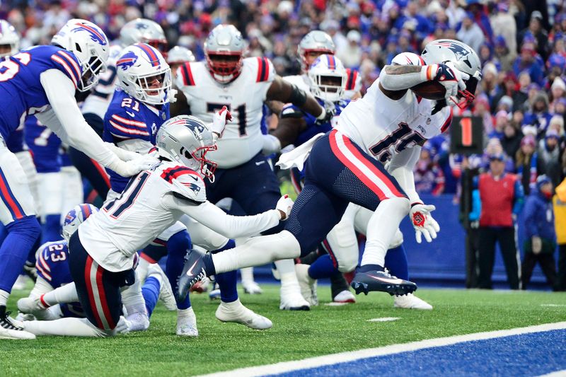 New England Patriots running back Ezekiel Elliott (15) rushes for a touchdown during the second half of an NFL football game against the Buffalo Bills in Orchard Park, N.Y., Sunday, Dec. 31, 2023. (AP Photo/Adrian Kraus)