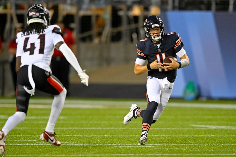 Chicago Bears quarterback Brett Rypien (11) runs with the ball with Houston Texans safety Calen Bullock (41) defending during the first half of the NFL exhibition Hall of Fame football game, in Canton, Ohio, Thursday, Aug. 1, 2024. (AP Photo/David Richard)