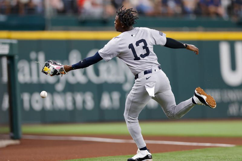 Sep 4, 2024; Arlington, Texas, USA; New York Yankees third base Jazz Chisholm Jr. (13) tries to run down a foul ball during the sixth inning against the Texas Rangers at Globe Life Field. Mandatory Credit: Andrew Dieb-Imagn Images