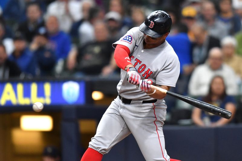 May 28, 2025; Milwaukee, Wisconsin, USA; Boston Red Sox designated hitter Rafael Devers (11) hits a two run single during the fourth inning against the Milwaukee Brewers at American Family Field. Mandatory Credit: Patrick Gorski-Imagn Images