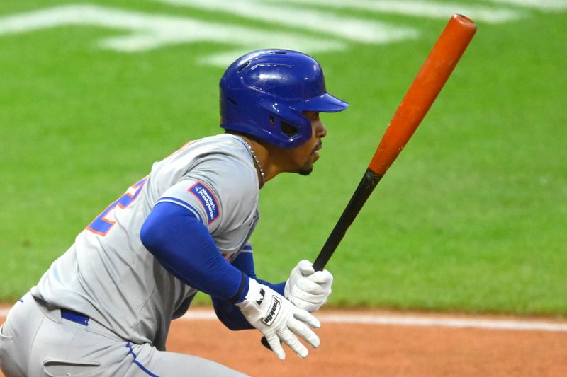 May 21, 2024; Cleveland, Ohio, USA; New York Mets shortstop Francisco Lindor (12) singles in the ninth inning against the Cleveland Guardians at Progressive Field. Mandatory Credit: David Richard-USA TODAY Sports