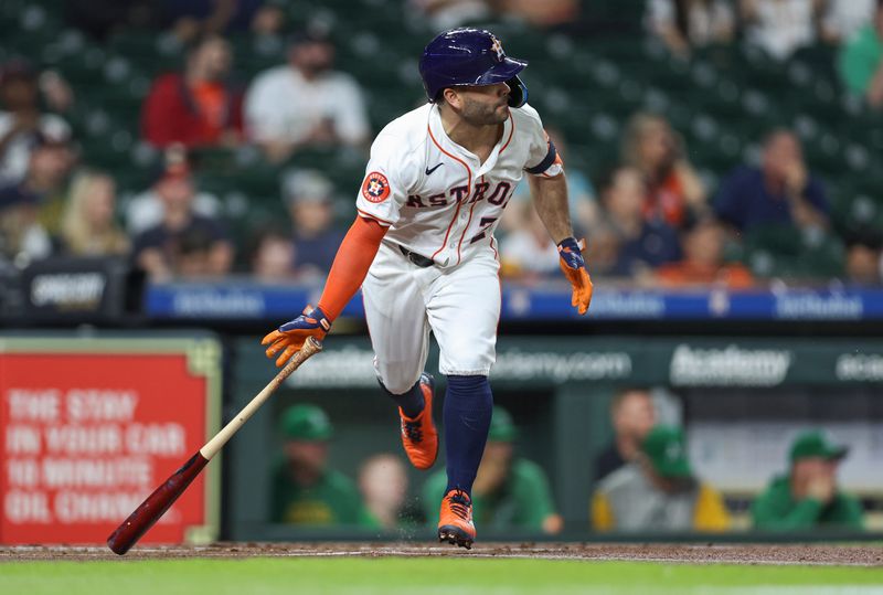 May 16, 2024; Houston, Texas, USA; Houston Astros second baseman Jose Altuve (27) hits a single during the first inning against the Oakland Athletics at Minute Maid Park. Mandatory Credit: Troy Taormina-USA TODAY Sports