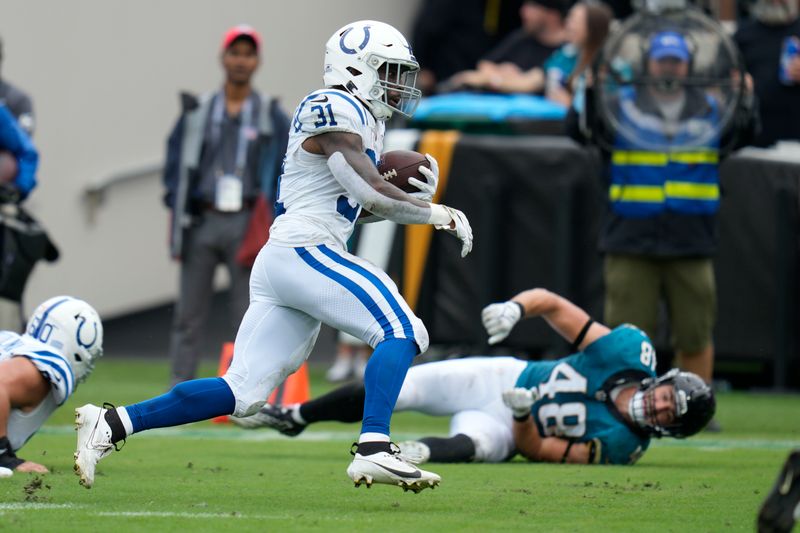 Indianapolis Colts running back Tyler Goodson (31) runs for a first down during the first half of an NFL football game against the Jacksonville Jaguars, Sunday, Oct. 6, 2024, in Jacksonville, Fla. (AP Photo/John Raoux)