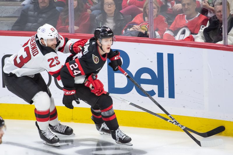 Apr 6, 2024; Ottawa, Ontario, CAN; New Jersey Devils left wing kurtis MacDermid (23) and Ottawa Senators defenseman Jacob Bernard-Docker (24) chase the puck in the third period at the Canadian Tire Centre. Mandatory Credit: Marc DesRosiers-USA TODAY Sports