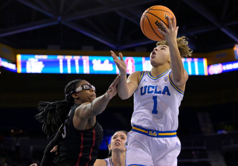 Jan 13, 2023; Los Angeles, California, USA; UCLA Bruins guard Kiki Rice (1) gets by Stanford Cardinal forward Francesca Belibi (5) for a basket in the first half at Pauley Pavilion presented by Wescom. Mandatory Credit: Jayne Kamin-Oncea-USA TODAY Sports