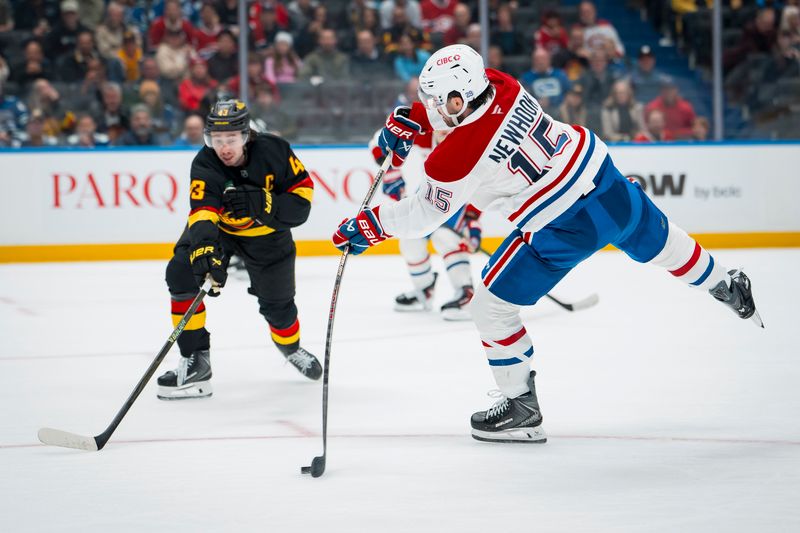 Oct 25, 2025; Vancouver, British Columbia, CAN; Montreal Canadiens forward Alex Newhook (15) shoots around Vancouver Canucks defenseman Quinn Hughes (43) in the third period at Rogers Arena. Mandatory Credit: Bob Frid-Imagn Images