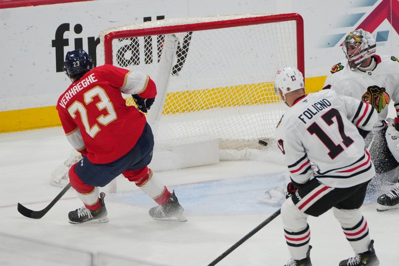 Feb 1, 2025; Sunrise, Florida, USA; Florida Panthers center Carter Verhaeghe (23) scores a goal past Chicago Blackhawks goaltender Petr Mrazek (34) in the third period at Amerant Bank Arena. Mandatory Credit: Jim Rassol-Imagn Images