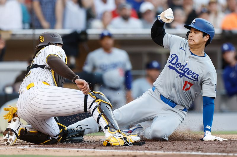 Jul 31, 2024; San Diego, California, USA; San Diego Padres catcher Luis Campusano (12) tags Los Angeles Dodgers designated hitter Shohei Ohtani (17) out at the plate to end the third inning against the Los Angeles Dodgers at Petco Park. Mandatory Credit: David Frerker-USA TODAY Sports