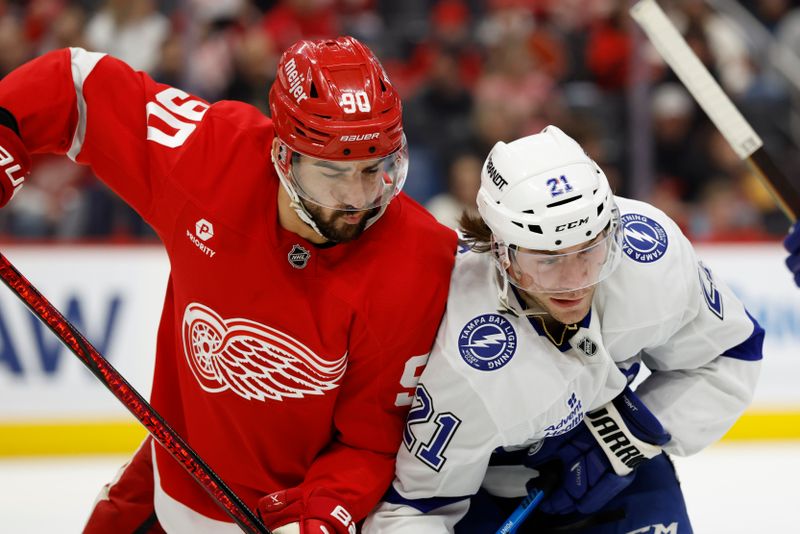 Jan 25, 2025; Detroit, Michigan, USA;  Detroit Red Wings center Joe Veleno (90) and Tampa Bay Lightning center Brayden Point (21) fight for position in the third period at Little Caesars Arena. Mandatory Credit: Rick Osentoski-Imagn Images