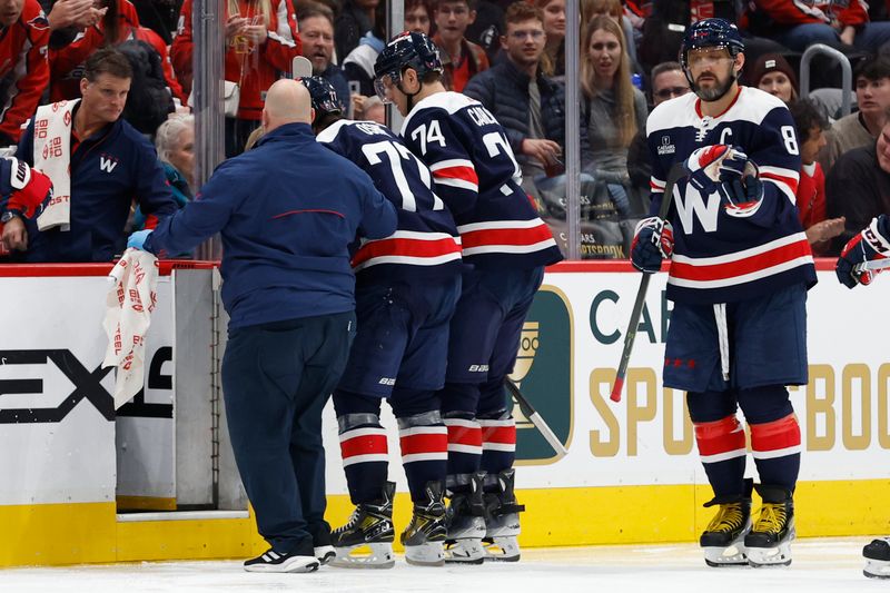 Nov 24, 2023; Washington, District of Columbia, USA; Washington Capitals right wing T.J. Oshie (77) is helped off the ice after being injured against the Edmonton Oilers in the second period at Capital One Arena. Mandatory Credit: Geoff Burke-USA TODAY Sports