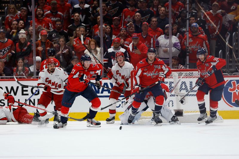 May 8, 2025; Washington, District of Columbia, USA; Washington Capitals center Aliaksei Protas (21) chases a loose puck against the Carolina Hurricanes in the third period in game two of the second round of the 2025 Stanley Cup Playoffs at Capital One Arena. Mandatory Credit: Geoff Burke-Imagn Images