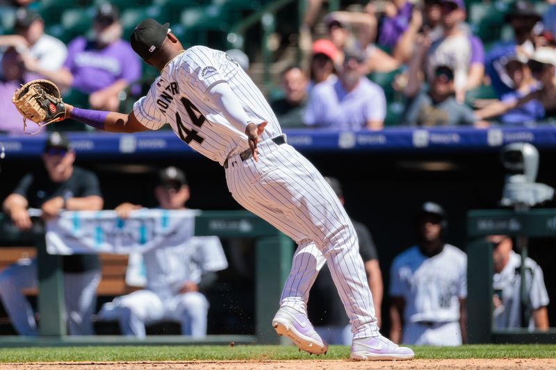 Jun 5, 2024; Denver, Colorado, USA; Colorado Rockies first base Elehuris Montero (44) reaches to catch for an out during the fifth inning against the Cincinnati Reds at Coors Field. Mandatory Credit: Andrew Wevers-USA TODAY Sports