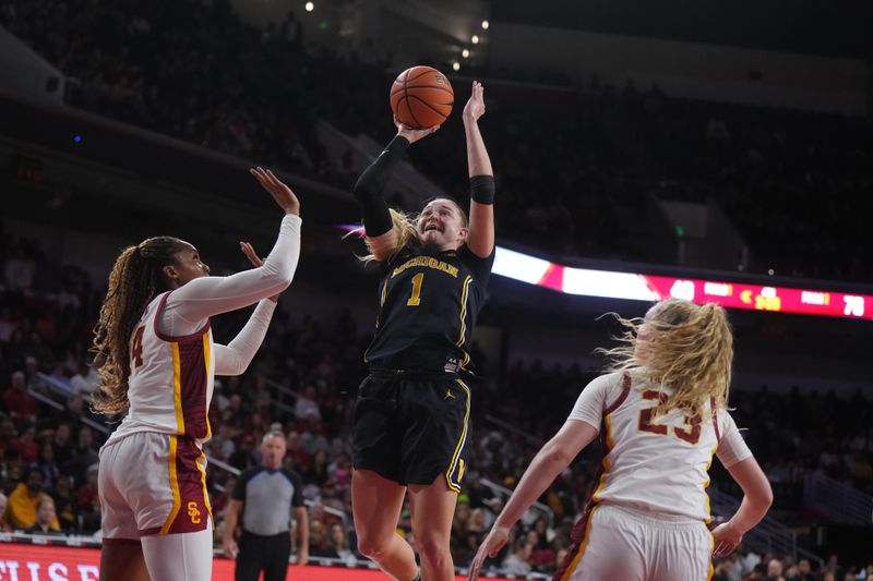 Dec 29, 2024; Los Angeles, California, USA; Michigan Wolverines guard Olivia Olson (1) shoots the ball against Southern California Trojans forward Kiki Iriafen (44) and Southern California Trojans guard Avery Howell (23) in the second half at Galen Center. Mandatory Credit: Kirby Lee-Imagn Images