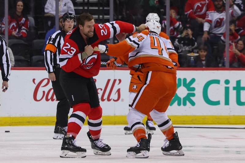 Oct 27, 2024; Newark, New Jersey, USA; Anaheim Ducks left wing Ross Johnston (44) and New Jersey Devils left wing Kurtis MacDermid (23) fight during the first period at Prudential Center. Mandatory Credit: Ed Mulholland-Imagn Images