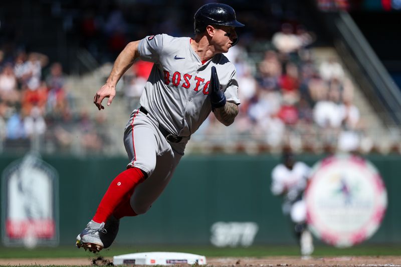 May 5, 2024; Minneapolis, Minnesota, USA; Boston Red Sox Tyler O'Neill (17) rounds third to score on a double hit by Vaughn Grissom (5) during the eighth inning against the Minnesota Twins at Target Field. Mandatory Credit: Matt Krohn-USA TODAY Sports