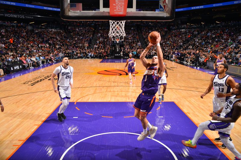 PHOENIX, AZ - FEBRUARY 13: Devin Booker #1 of the Phoenix Suns drives to the basket during the game against the Sacramento Kings on February 13, 2024 at Footprint Center in Phoenix, Arizona. NOTE TO USER: User expressly acknowledges and agrees that, by downloading and or using this photograph, user is consenting to the terms and conditions of the Getty Images License Agreement. Mandatory Copyright Notice: Copyright 2024 NBAE (Photo by Barry Gossage/NBAE via Getty Images)