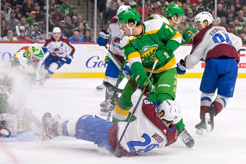 Nov 24, 2023; Saint Paul, Minnesota, USA; Colorado Avalanche forward Miles Wood (28) looses an edge as he goes to the net while Minnesota Wild defenseman Brock Faber (7) defends during the first period at Xcel Energy Center. Mandatory Credit: Nick Wosika-USA TODAY Sports