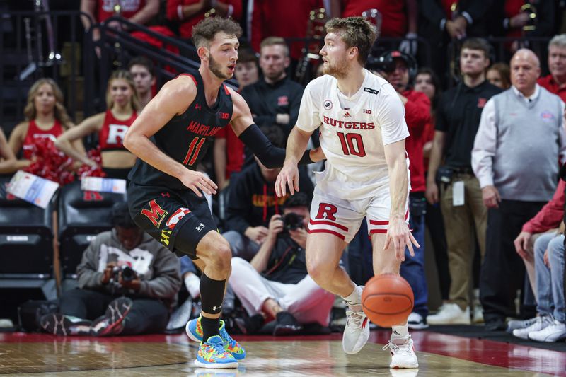 Jan 5, 2023; Piscataway, New Jersey, USA; Rutgers Scarlet Knights guard Cam Spencer (10) dribbles as Maryland Terrapins forward Noah Batchelor (11) defends during the first half at Jersey Mike's Arena. Mandatory Credit: Vincent Carchietta-USA TODAY Sports